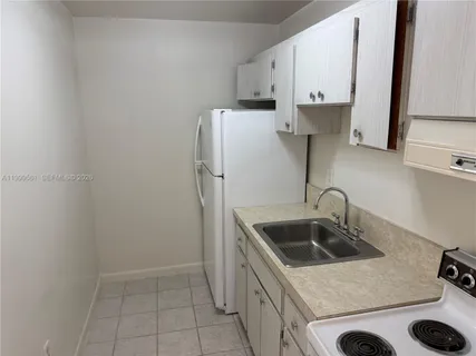 a kitchen with a sink a stove and refrigerator