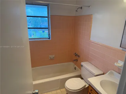 a bathroom with a toilet and a bathtub