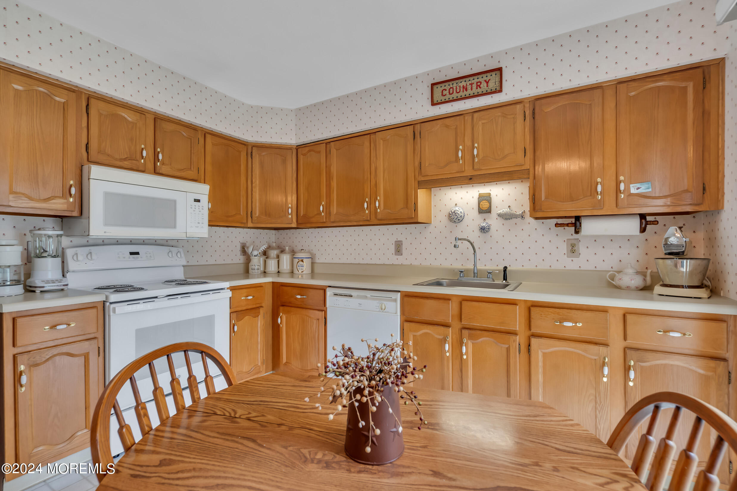 7 Amherst Road, Unit C Manchester Township, NJ 08759 - Photo 11 of 25 a kitchen with stainless steel appliances granite countertop a stove top oven a sink dishwasher and cabinets with wooden floor