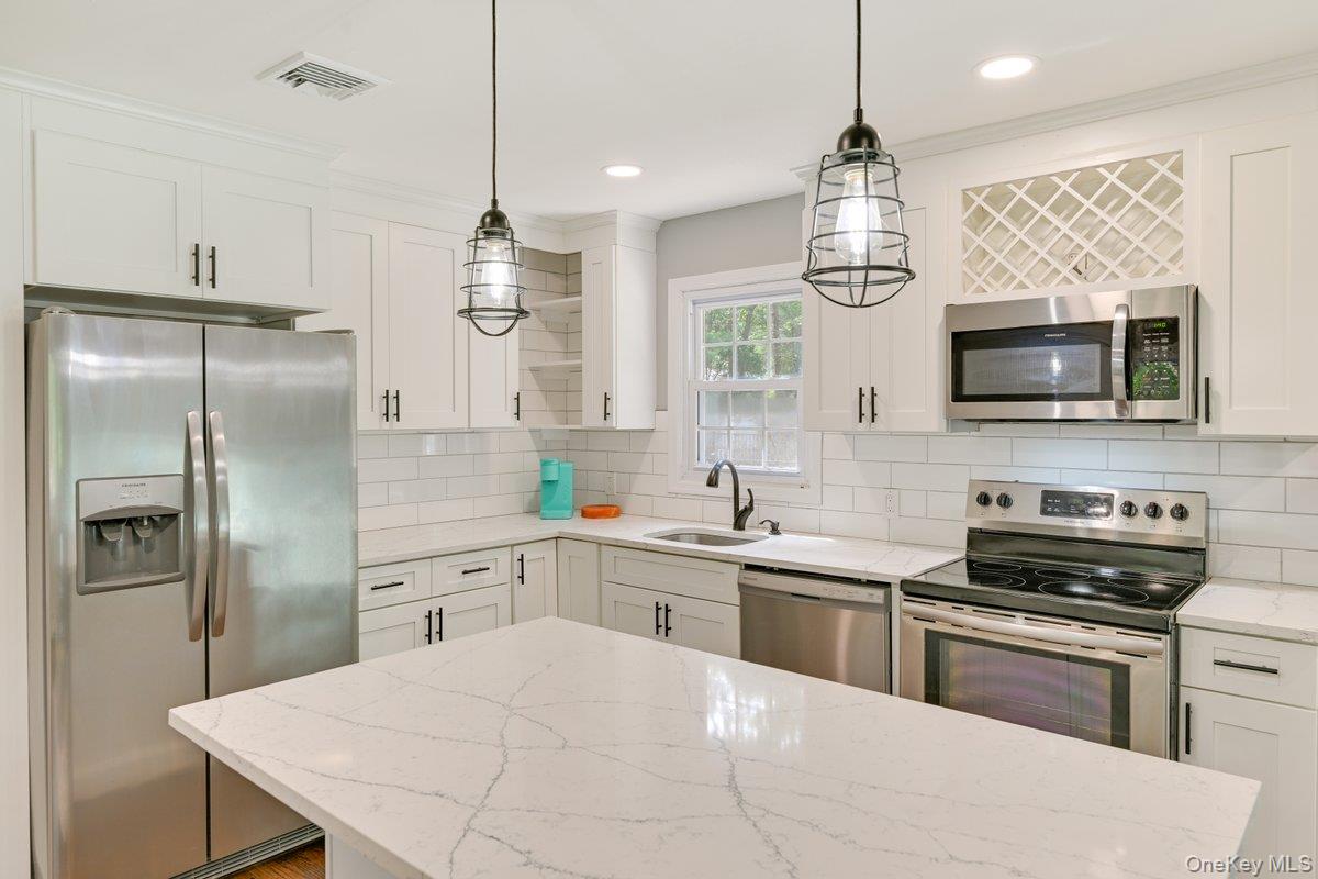 2 Fairview Road Hampton Bays, NY 11946 - Photo 3 of 17 Recently update open kitchen with quartzite counters and stainless steel appliances