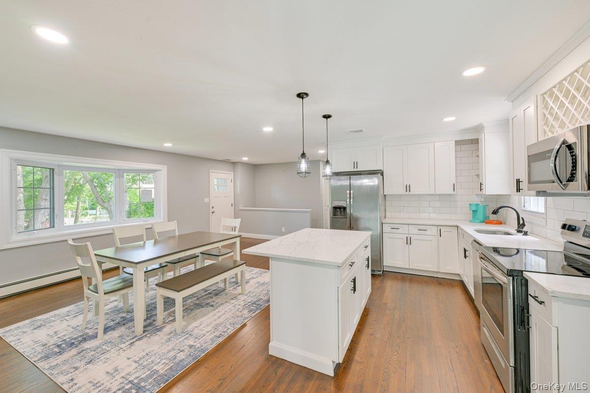 2 Fairview Road Hampton Bays, NY 11946 - Photo 7 of 17 Kitchen and dining area provide ample eating space for you and your guests