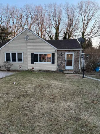 a front view of house with yard and trees