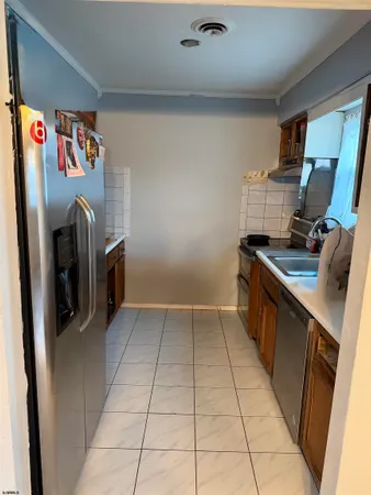 a kitchen with stainless steel appliances granite countertop a refrigerator and a stove