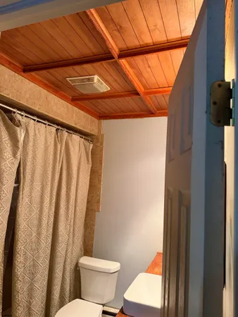 a bathroom with a toilet and shower