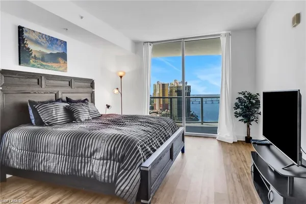 a bedroom with bed and flat screen tv