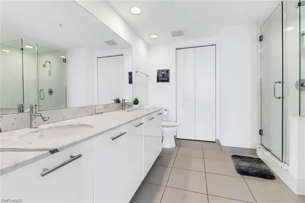 a spacious bathroom with a granite countertop sink a mirror and a