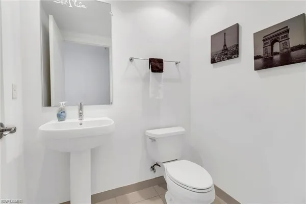 a white toilet sitting next to a bathroom sink