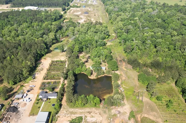 a view of residential house with swimming pool and lawn chairs