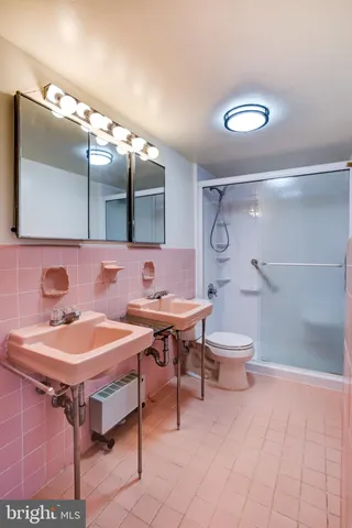 a view of a swimming pool with a bench and trees in the background