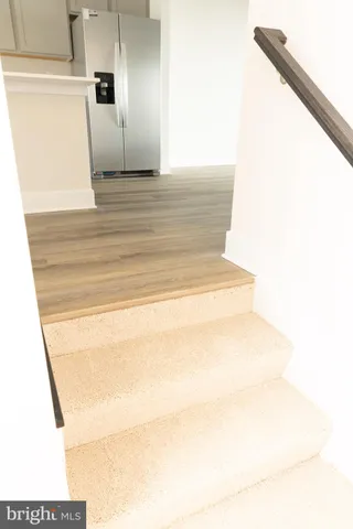 a kitchen with stainless steel appliances a refrigerator sink and microwave