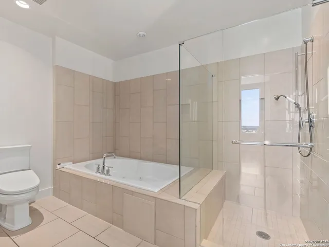 a bathroom with a bathtub and toilet