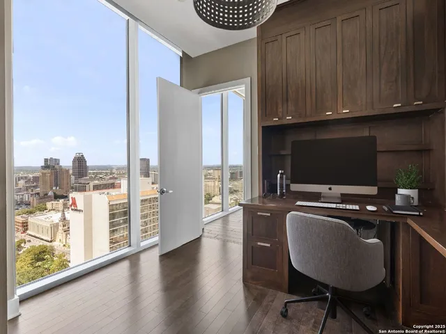 a view of a kitchen with workspace and wooden floor