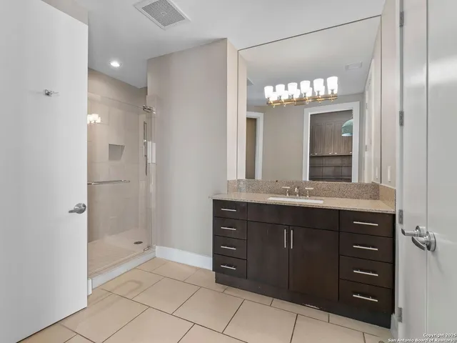 a bathroom with a granite countertop sink a mirror and a