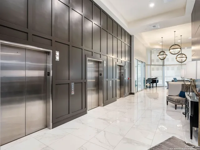 a large kitchen with stainless steel appliances kitchen island granite countertop a refrigerator a stove and a sink with large cabinets