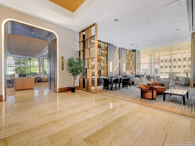 a living room with furniture and large windows