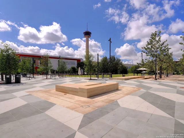 a view of fountain with a yard