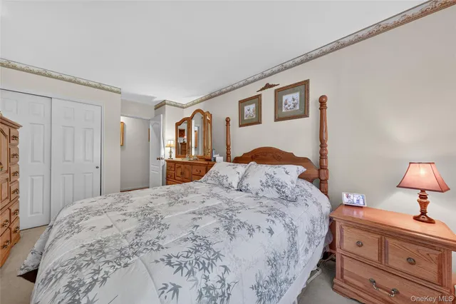 a bedroom with a large bed and a dresser