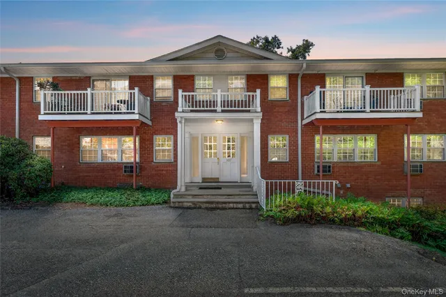 front view of a brick house with a small yard