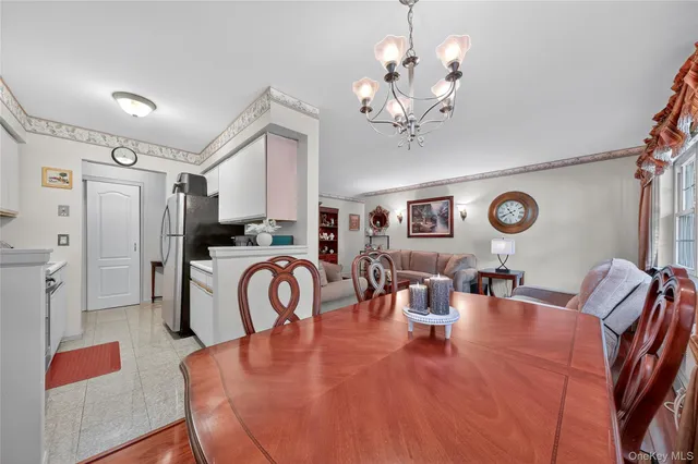 a view of a dining room with furniture and a chandelier