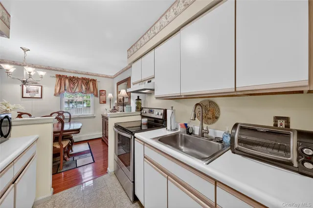 a kitchen with stainless steel appliances a sink a stove and a refrigerator