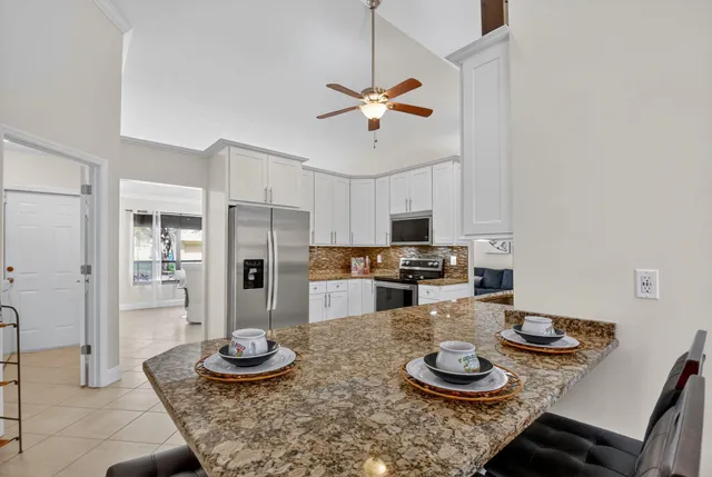 a kitchen with stainless steel appliances granite countertop a stove and a refrigerator
