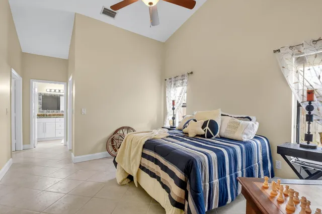 a bedroom with two beds and painting on the wall
