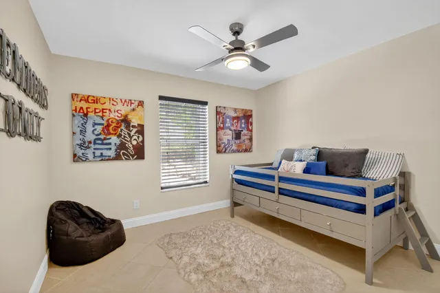 a bed room with a bed and a chair