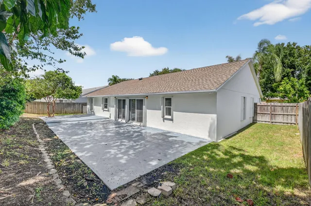 a view of a house with a yard and a garden