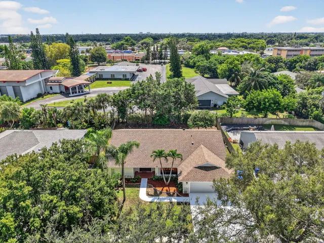 an aerial view of a house with yard swimming pool and outdoor seating