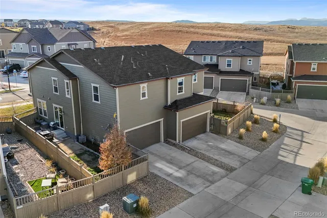 an aerial view of a city with lots of residential buildings and mountain view in back