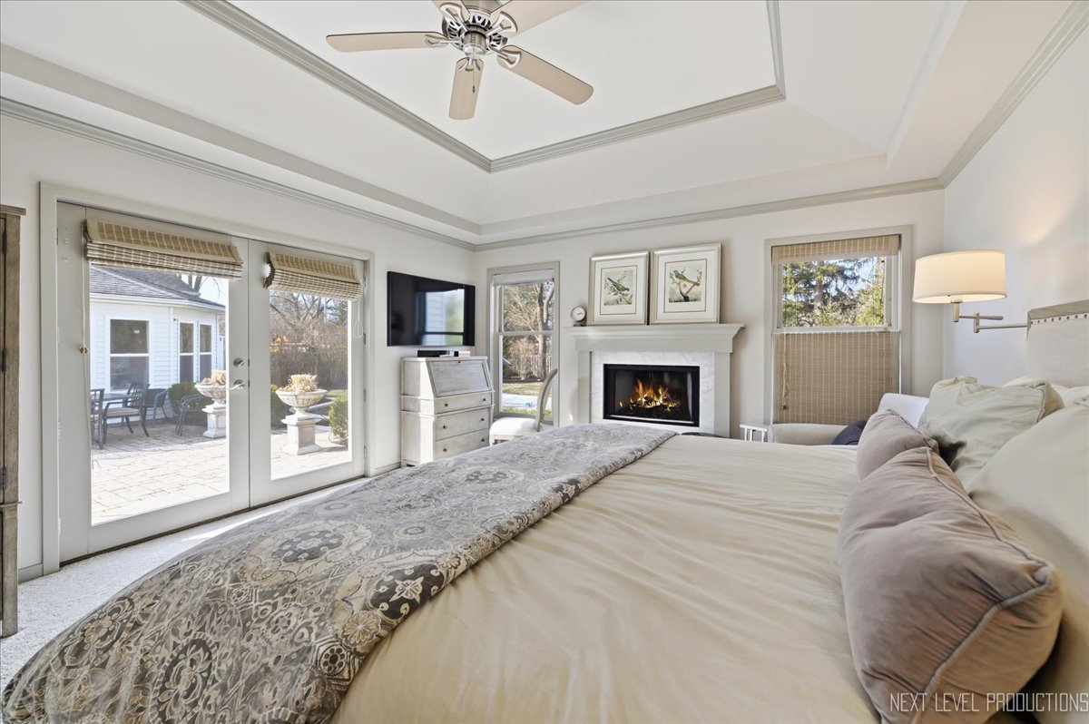 629 Peck Road Geneva, IL 60134 - Photo 17 of 38 a bedroom with a large bed and a fireplace