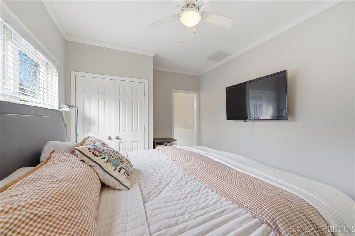 629 Peck Road Geneva, IL 60134 - Photo 27 of 38 a bedroom with a bed and a flat screen tv