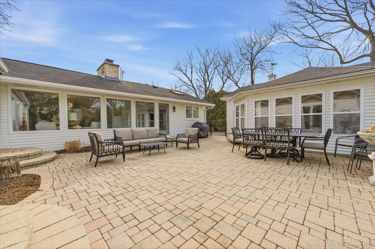 629 Peck Road Geneva, IL 60134 - Photo 30 of 38 a view of a house with sitting area and wooden fence