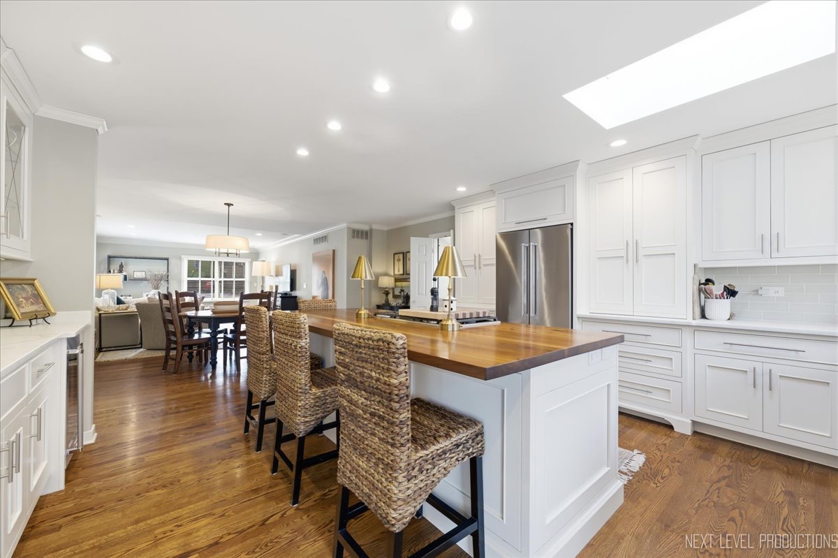 629 Peck Road Geneva, IL 60134 - Photo 7 of 38 a kitchen with lots of counter top space and painting on the wall