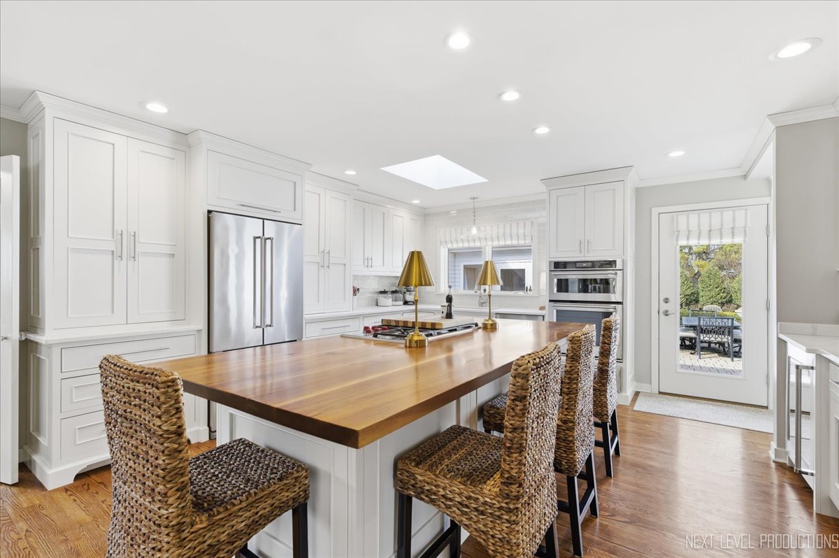 629 Peck Road Geneva, IL 60134 - Photo 8 of 38 a kitchen with stainless steel appliances a dining table chairs and wooden floor