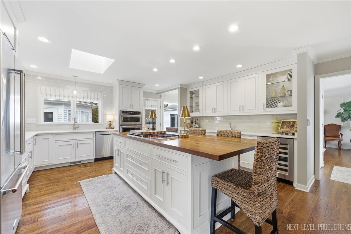 629 Peck Road Geneva, IL 60134 - Photo 10 of 38 a kitchen with a sink window and cabinets