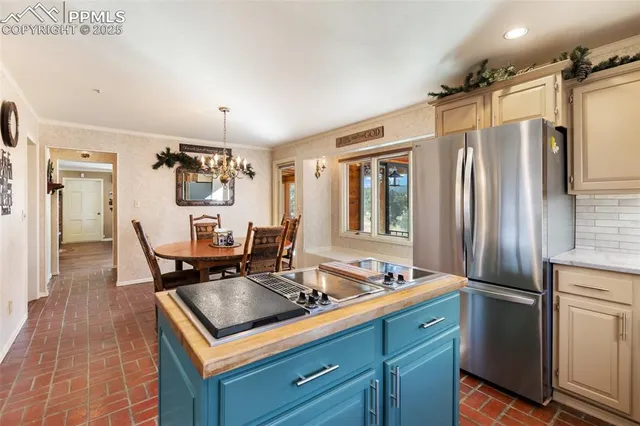 a kitchen with stainless steel appliances sink stove refrigerator and cabinets