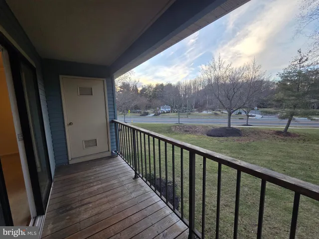 a balcony with wooden floor and fence