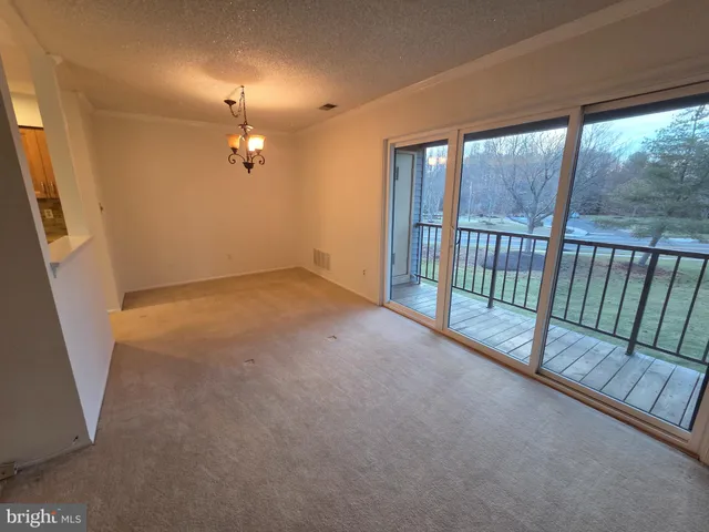 an empty room with windows and entrance