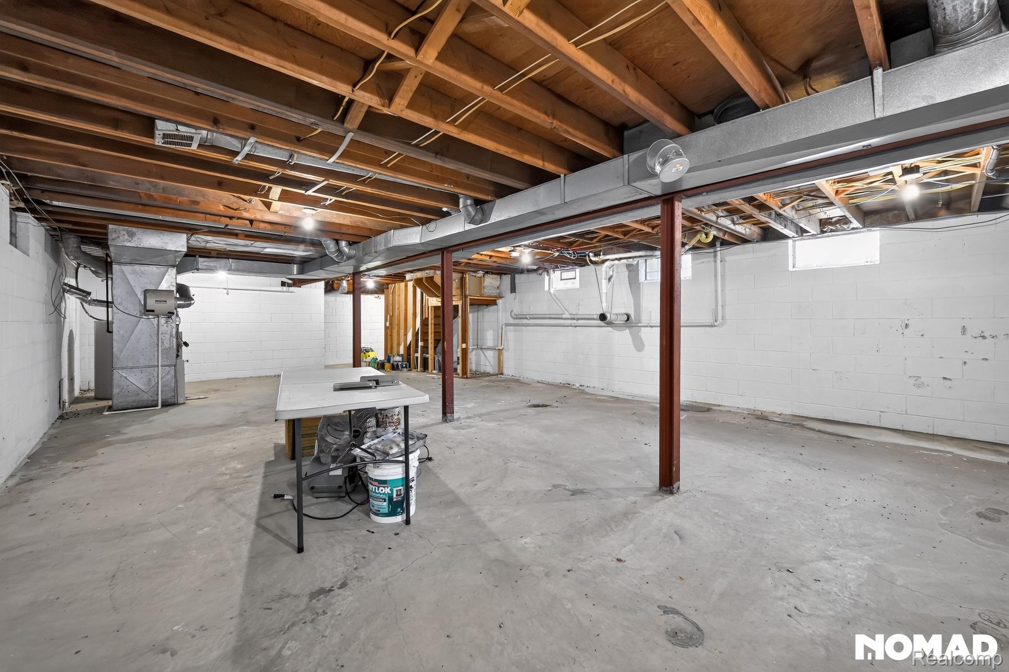 8315 Hilton Road Brighton, MI 48114 - Photo 23 of 26 Unfinished basement featuring exposed wood joists, concrete block walls, concrete flooring, and visible ductwork