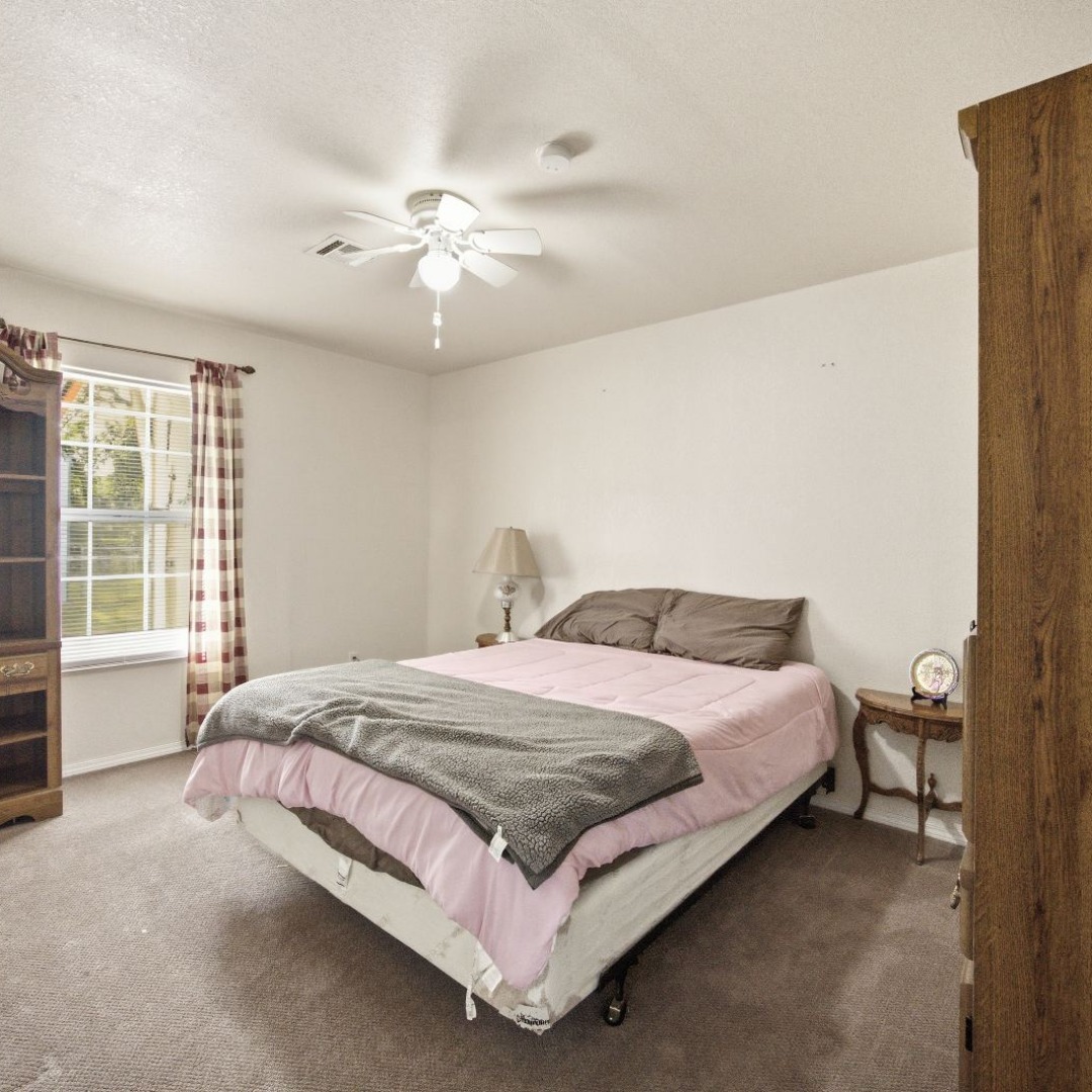 2696 Russellville Road Quinton, OK 74561 - Photo 13 of 40 Carpeted room featuring a white ceiling fan with integrated lighting, a multi-pane window, and light-toned walls