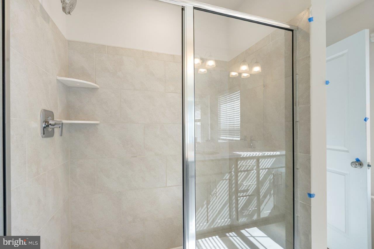 7519 Silver Thread Way Brandywine, MD 20613 - Photo 13 of 32 a bathroom with a glass shower door