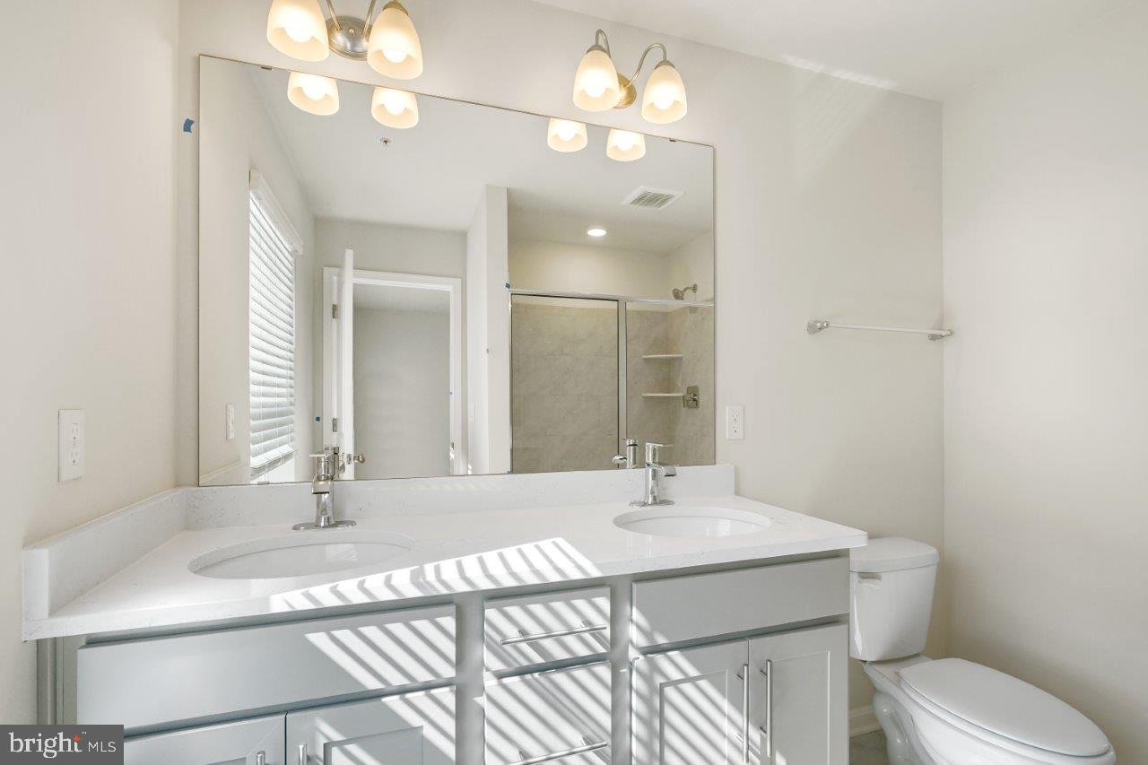 7519 Silver Thread Way Brandywine, MD 20613 - Photo 14 of 32 a bathroom with a sink a toilet and a mirror