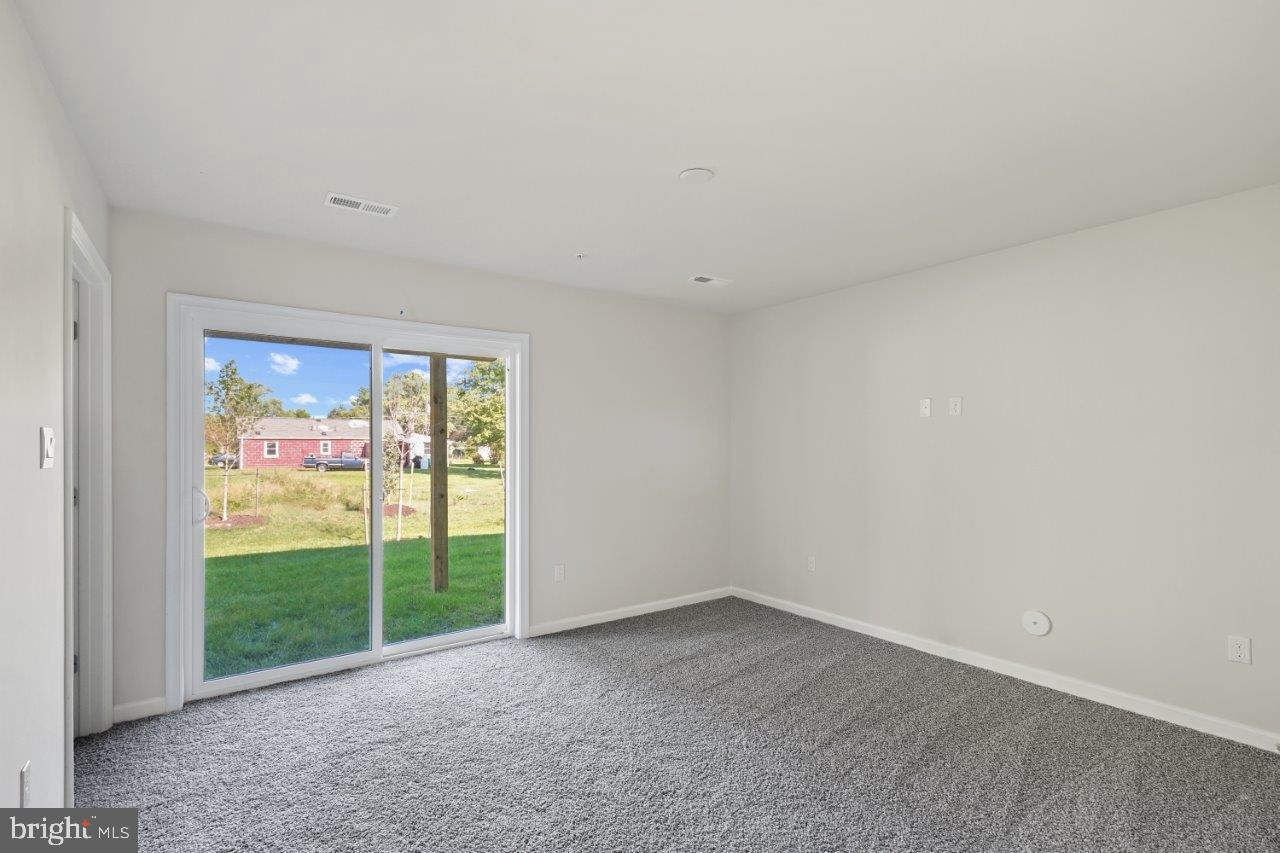 7519 Silver Thread Way Brandywine, MD 20613 - Photo 4 of 32 a view of an empty room with glass door