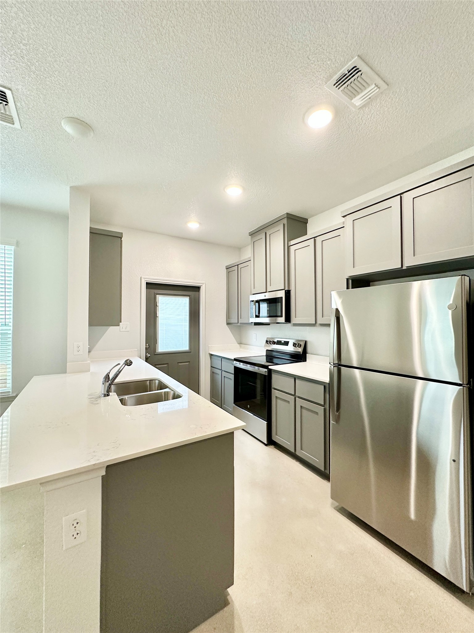 2321 Ocean Avenue, Unit B Temple, TX 76501 - Photo 5 of 19 a kitchen with a refrigerator a stove top oven a sink and cabinets