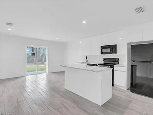 a kitchen with stainless steel appliances a sink stove and refrigerator