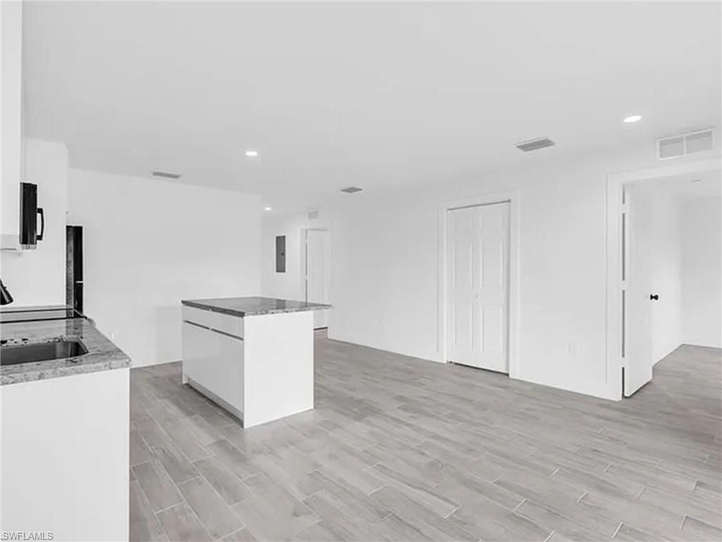 3120 Peters Avenue Naples, FL 34112 - Photo 4 of 12 a kitchen with a refrigerator and a stove top oven