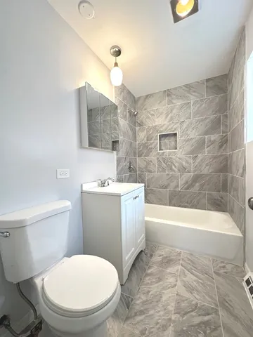 a bathroom with a sink a toilet and bathtub