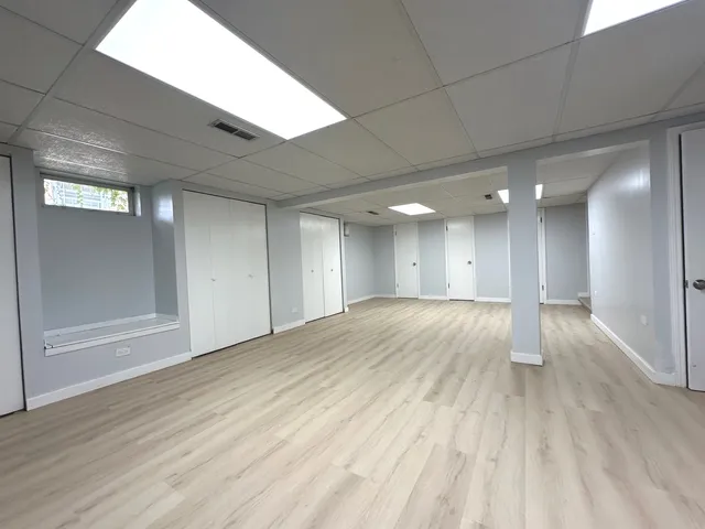 a view of an empty room and wooden floor