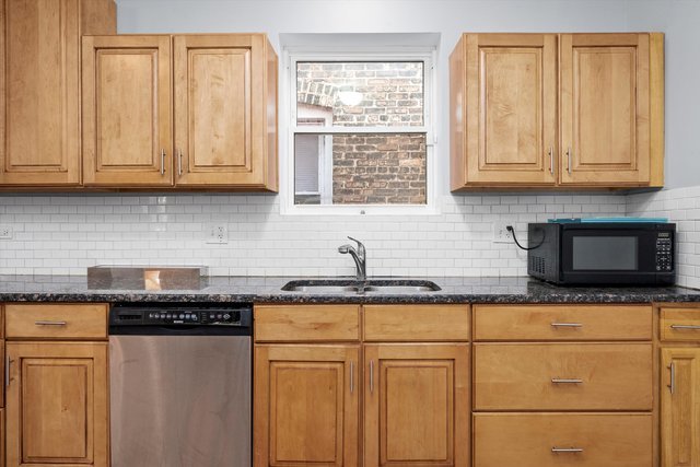 8100 South Houston Avenue Chicago, IL 60617 - Photo 15 of 55 a kitchen with stainless steel appliances granite countertop a stove a sink and a microwave